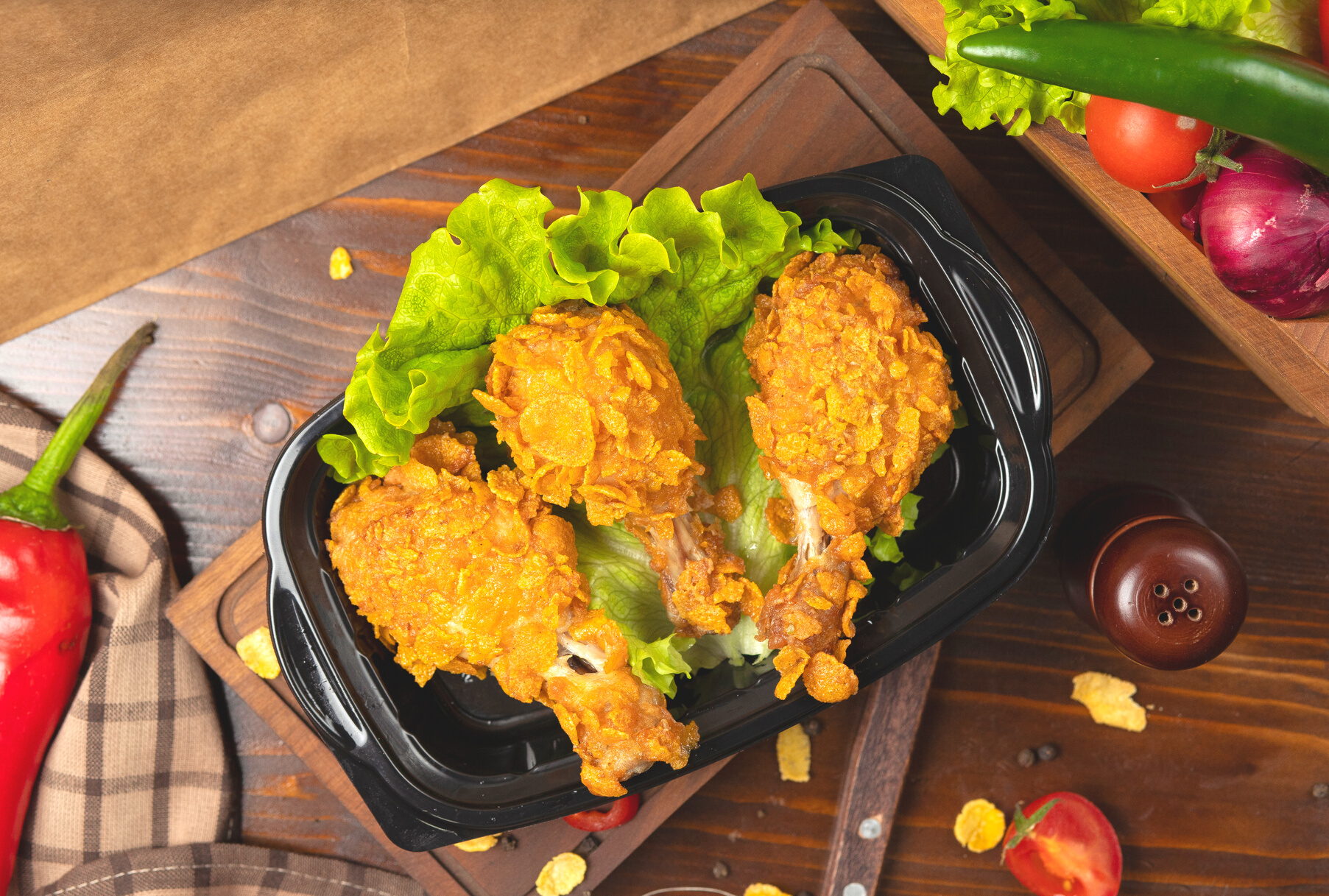Crispy chicken drumsticks grilled kfc style with crackers takeaway.